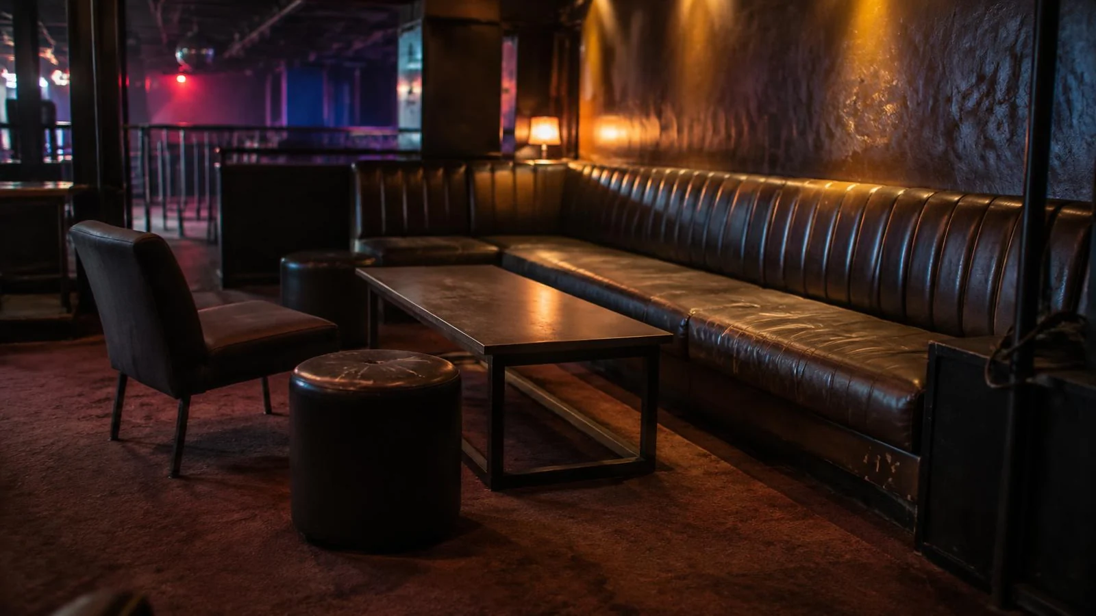 An empty VIP room in a Bangkok club before opening, with a long banquette and a bare low table