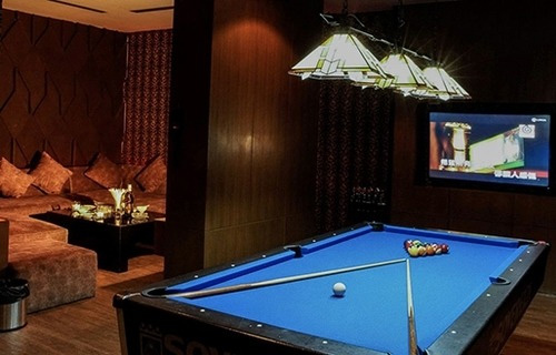 A medium private room with a pool table and seating for six